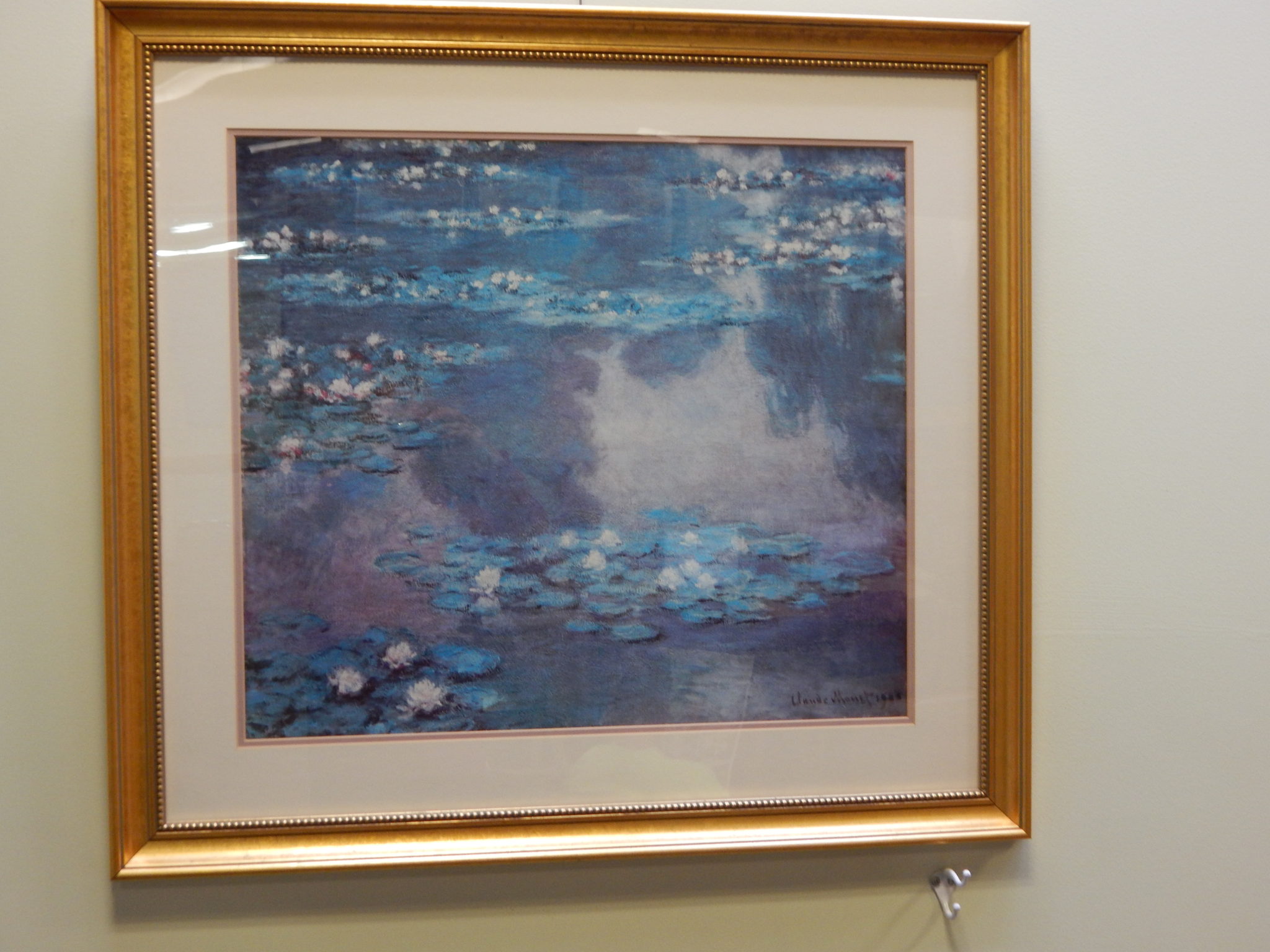 print of lily pads on water by Claude Monet